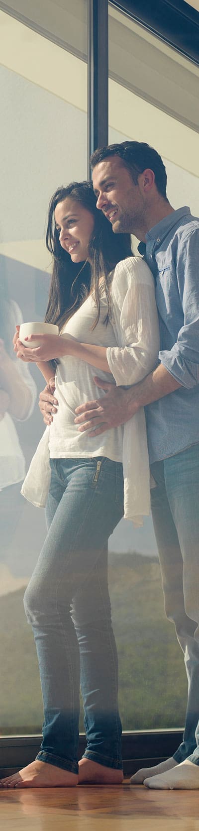 Young couple at window with drink