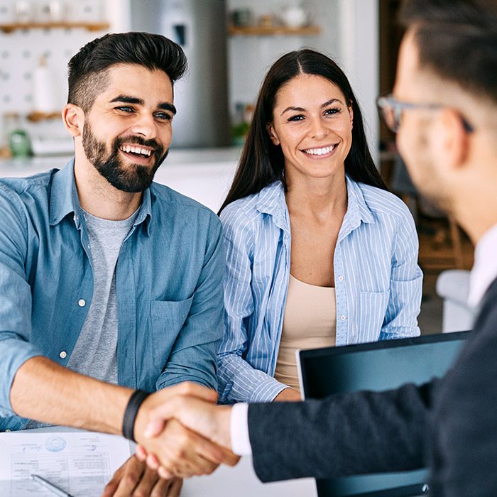 Young couple meeting with agent regarding financial advice